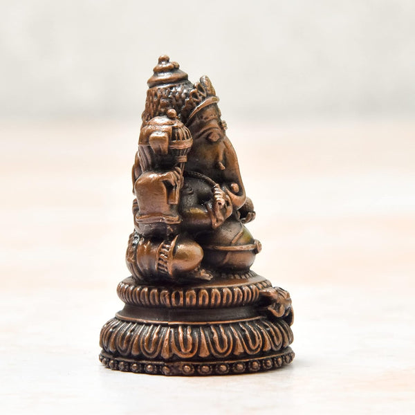 Handcrafted antique-finished copper statue of Lord Ganesha, the remover of obstacles, measuring 3L x 3W x 5H cm