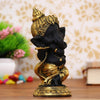 Handmade Golden and Black Polyresin Ganesha idol playing flute, intricately detailed, symbolizing wisdom and prosperity, ideal for home decor and altars