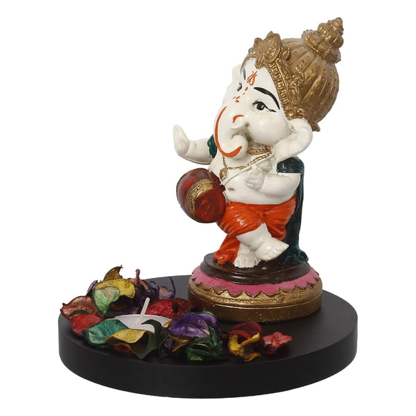 Handcrafted Ganesha home decor set featuring a polyresin idol, lotus-shaped tealight holder, and wooden tray, symbolizing prosperity and elegance."
