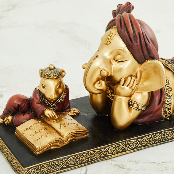 Handmade Lord Ganesh idol crafted from resin, showcasing intricate details and vibrant colors. Perfect for altars and car dashboards."