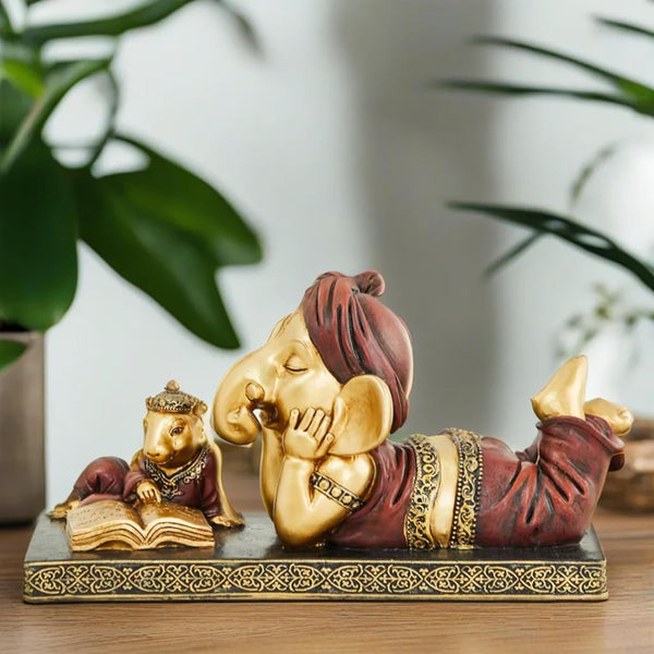 Handmade Lord Ganesh idol crafted from resin, showcasing intricate details and vibrant colors. Perfect for altars and car dashboards."