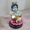 Handmade Lord Krishna Makhan Chor idol, crafted from high-quality resin, featuring vibrant colors and intricate detailing, capturing Krishna's playful charm