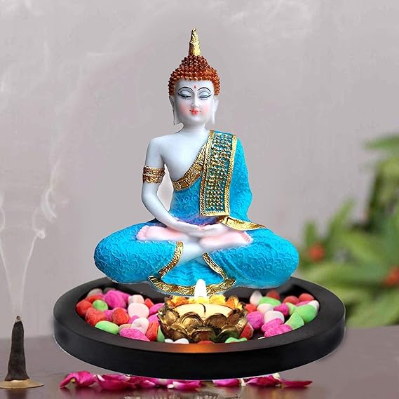 A serene Lord Buddha statue crafted from high-quality resin, featuring intricate hand-carved details and a peaceful expression, displayed with a tealight holder and decorative flower