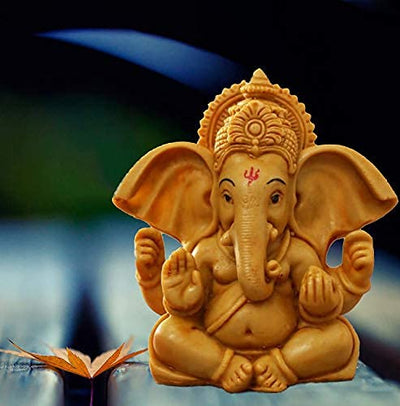Elegant metal Lord Ganesha statue on a round base, representing divine blessings and spiritual charm, suitable for altars and home decor.
