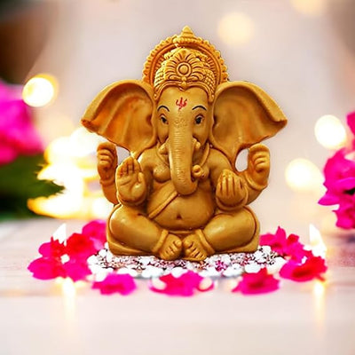 Elegant metal Lord Ganesha statue on a round base, representing divine blessings and spiritual charm, suitable for altars and home decor.