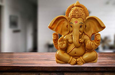Elegant metal Lord Ganesha statue on a round base, representing divine blessings and spiritual charm, suitable for altars and home decor.