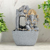 A water fountain featuring a statue of Lord Ganesha, the Hindu god of wisdom and remover of obstacles. Water flows around or from the statue, creating a serene and calming atmosphere. The fountain may be made of stone, marble, or other materials and may have additional decorative elements, such as plants or lights