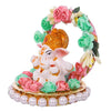  A small golden idol of Lord Ganesha, the Hindu god of wisdom and remover of obstacles, placed on a car dashboard