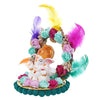 A small golden idol of Lord Ganesha, the Hindu god of wisdom and remover of obstacles, seated on a throne made of colorful flowers. The idol is placed on a car dashboard.