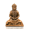 A small golden idol of Lord Hanuman, the Hindu monkey god, seated on a throne made of colorful flowers. The idol is placed on a car dashboard.