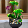 A table-top fountain featuring a lotus pond with water gently flowing around and over the lotus flowers.