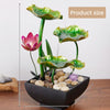 A table-top fountain featuring a lotus pond with water gently flowing around and over the lotus flowers.