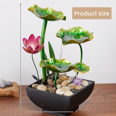A table-top fountain featuring a lotus pond with water gently flowing around and over the lotus flowers.