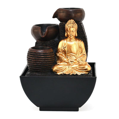 A water fountain featuring a statue of Buddha seated in meditation pose. Water flows from the Buddha's hands or from a nearby source, creating a serene and calming atmosphere. The fountain may be made of stone, marble, or other materials and may have additional decorative elements.