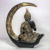 A decorative statue of Buddha seated in meditation pose under a crescent moon. The statue may be made of marble, stone, or another material and may have a serene and calming expression.