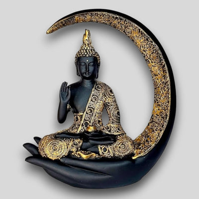 A decorative statue of Buddha seated in meditation pose under a crescent moon. The statue may be made of marble, stone, or another material and may have a serene and calming expression.