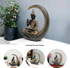 A decorative statue of Buddha seated in meditation pose under a crescent moon. The statue may be made of marble, stone, or another material and may have a serene and calming expression.