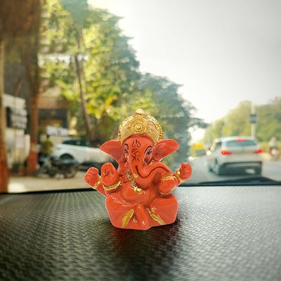 A miniature statue of Lord Ganesha, the Hindu god of wisdom and remover of obstacles.