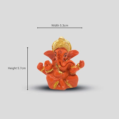 A miniature statue of Lord Ganesha, the Hindu god of wisdom and remover of obstacles.