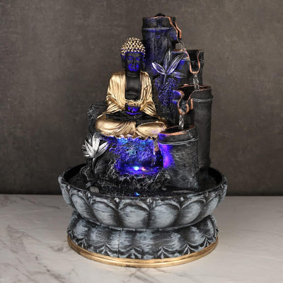 A small, tabletop fountain made of polyresin, a durable and lightweight material. Water flows through the fountain, creating a soothing sound. The fountain may have additional decorative elements, such as rocks, plants, or a figurine.