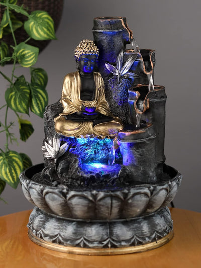 A small, tabletop fountain made of polyresin, a durable and lightweight material. Water flows through the fountain, creating a soothing sound. The fountain may have additional decorative elements, such as rocks, plants, or a figurine.