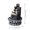 A small, tabletop fountain made of polyresin, a durable and lightweight material. Water flows through the fountain, creating a soothing sound. The fountain may have additional decorative elements, such as rocks, plants, or a figurine.