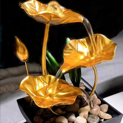 A three-tiered tabletop fountain featuring cascading waterfalls and a decorative base. The fountain may be made of ceramic, stone, or other materials and may have additional decorative elements, such as plants or lights.