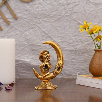 Handcrafted metal statue of Baby Krishna playing the flute, featuring a gold finish, representing joy and divine playfulness.