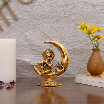 Handcrafted metal statue of Baby Krishna playing the flute, featuring a gold finish, representing joy and divine playfulness.