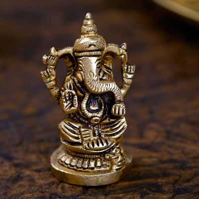 Handcrafted 100% brass Ganesha idol, measuring 4.8L x 3.8W x 6.8H cm, perfect for home altar or car dashboard, symbolizing prosperity and wisdom.