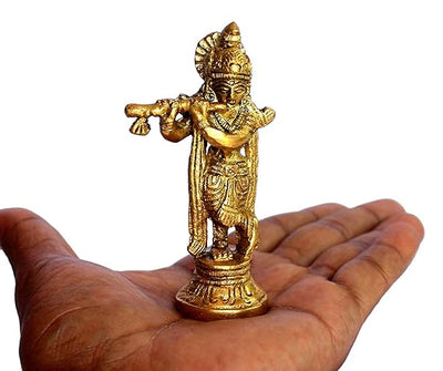 A beautifully crafted brass Murti of Lord Krishna, capturing his playful spirit. The idol is adorned with intricate details and vibrant colors.