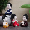 Collection of four serene Buddha monk statues made from durable resin, ideal for indoor and outdoor decor, promoting tranquility and harmony