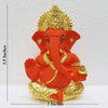 Handcrafted ceramic Ganesha idol with gold and sindoor orange finish, symbolizing prosperity and wisdom, ideal for altars and home decor.