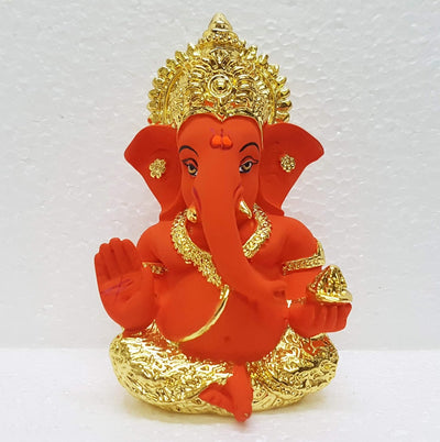 Handcrafted ceramic Ganesha idol with gold and sindoor orange finish, symbolizing prosperity and wisdom, ideal for altars and home decor.
