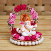 Captivating Lord Ganesha idol on a floral throne, dimensions 9x9x9.5 cm, weighing 200 grams, crafted from high-quality resin.