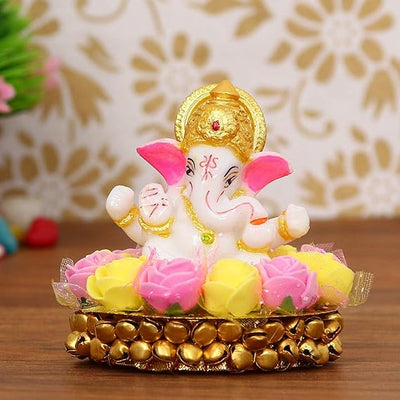 Handcrafted Lord Ganesha idol made of vibrant resin, measuring 8x8x8 cm, symbolizing prosperity and wisdom, placed on a decorative plate.