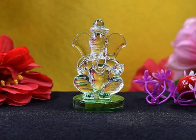Elegant handmade glass Ganesha idol, a beautifully crafted showpiece ideal for altars or car dashboards, radiating divine charm and intricate detail.