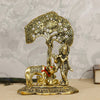 Intricate Lord Krishna showpiece in metal, depicting the deity playing the flute under a tree, surrounded by a golden cow and calf.