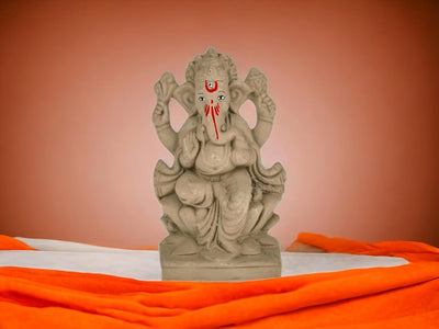 Handmade Ganesha idol in clay, perfect as a decorative showpiece, symbolizing wisdom and prosperity for home altars and decor.