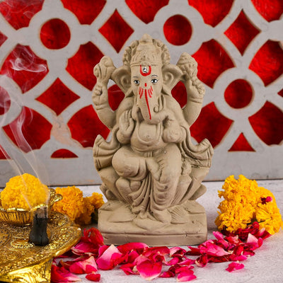 Handmade Ganesha idol in clay, perfect as a decorative showpiece, symbolizing wisdom and prosperity for home altars and decor.