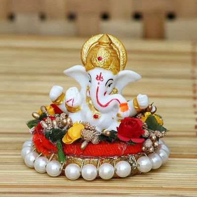Handmade Lord Ganesha idol on a decorative plate, crafted from resin. Dimensions 8.9x8.9x7.6 cm, weighing 400g. Ideal for home decor and gifting.