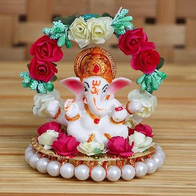 Handmade Lord Ganesha idol on a floral throne, crafted from resin. Dimensions: 9x9x9.5 cm, weight: 250g. Ideal for home decor and gifting.