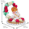Handmade Lord Ganesha idol on a floral throne, crafted from resin. Dimensions: 9x9x9.5 cm, weight: 250g. Ideal for home decor and gifting.