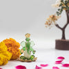 A handmade glass Ganesha idol, 4.5 cm x 6 cm, designed for car dashboards, showcasing intricate detailing and a spiritual aura.