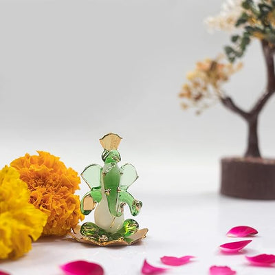 A handmade glass Ganesha idol, 4.5 cm x 6 cm, designed for car dashboards, showcasing intricate detailing and a spiritual aura.