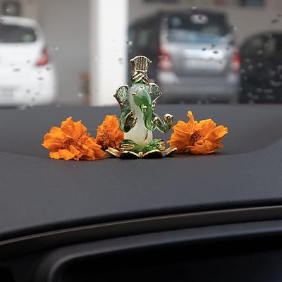 A handmade glass Ganesha idol, 4.5 cm x 6 cm, designed for car dashboards, showcasing intricate detailing and a spiritual aura.