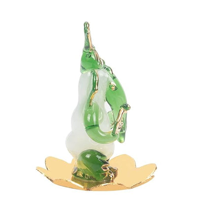 A handmade glass Ganesha idol, 4.5 cm x 6 cm, designed for car dashboards, showcasing intricate detailing and a spiritual aura.