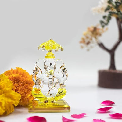 A beautiful handcrafted glass Ganesha idol, measuring 5 cm x 5 cm x 9 cm, ideal for car dashboards or home altars