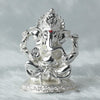 A beautifully crafted handmade Ganesha idol made of resin, showcasing intricate details and vibrant colors. The idol, symbolizing prosperity and wisdom, is positioned on a decorative altar surrounded by floral arrangements, representing its spiritual significance in Hinduism.