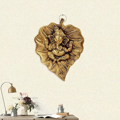 Handmade Ganesha wall hanging in metal, symbolizing wisdom and prosperity, perfect for home decor and altars.